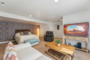 Basement bedroom featuring light colored carpet, recessed lighting, baseboards