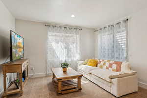 Basement bedroom / living area with carpet flooring, baseboards, and recessed lighting