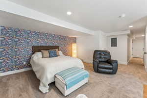 Basement bedroom with electric panel, carpet, baseboards, and recessed lighting