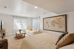 Basement bedroom / living area featuring carpet floors, recessed lighting, and baseboards