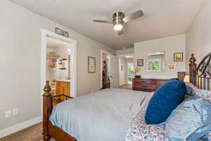 Primary bedroom a ceiling fan, walk-in closet and en-suite bathroom