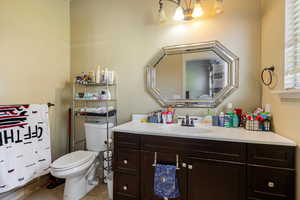Bathroom with light tile patterned floors and vanity