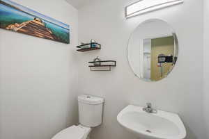 Half bath with a sink and toilet