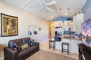 Living room featuring a ceiling fan and light tile patterned floors