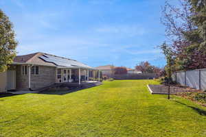 Fenced backyard featuring french doors