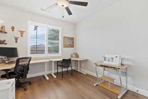 Office featuring wood finished floors, a ceiling fan, and baseboards