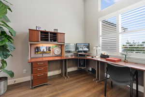 Home office featuring wood finished floors, plenty of natural light, and baseboards