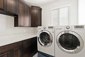 Laundry area with cabinet space and washer and clothes dryer