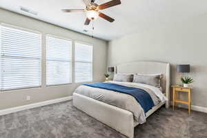 Bedroom with carpet flooring, baseboards, and ceiling fan