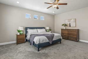 Bedroom featuring light carpet, baseboards, recessed lighting, and ceiling fan