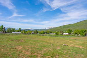 View of mountain backdrop with rural landscape and agricultural land