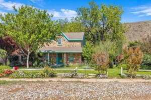 View of front of home with covered porch and a front yard