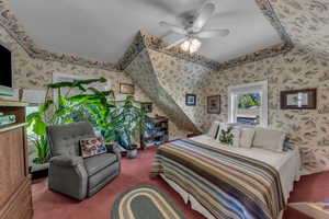 Carpeted bedroom with wallpapered walls