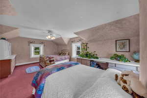 Bedroom with carpet floors, lofted ceiling, baseboards, and ceiling fan
