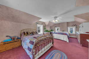 Bedroom featuring carpet, lofted ceiling, and ceiling fan