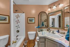 Full bathroom with toilet, vanity, bathing tub / shower combination, and tile patterned floors