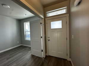 Entrance foyer featuring dark wood-style flooring and baseboards