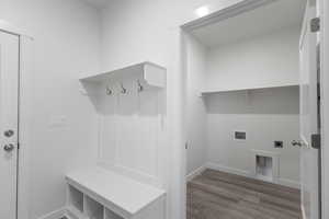Mudroom featuring wood finished floors and baseboards