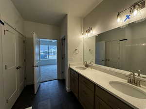 Full bathroom with double vanity and tile patterned floors