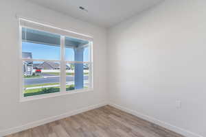 Unfurnished room with baseboards and light wood-style flooring