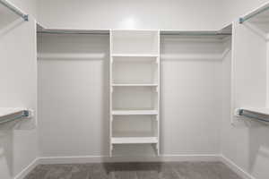 Spacious closet featuring carpet flooring