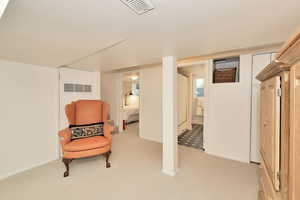 Sitting room with light carpet and baseboards
