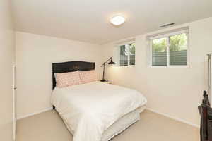 Carpeted bedroom featuring baseboards