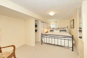 Bedroom featuring carpet flooring, baseboards, and a closet