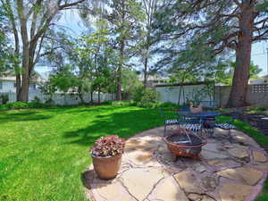 View of yard with a fire pit and a patio area