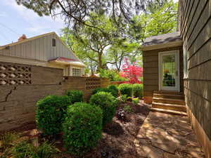 View of yard featuring entry steps and fence