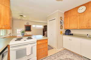 Kitchen featuring white electric range, dishwasher, light countertops, ceiling fan, and ornamental molding