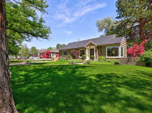 Ranch-style home featuring a front yard