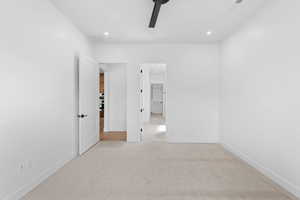 Unfurnished bedroom featuring light colored carpet, recessed lighting, baseboards, and ceiling fan
