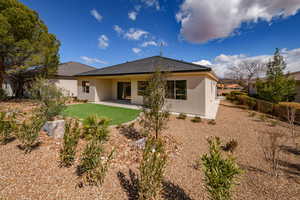 Rear view of property with stucco siding and a patio area