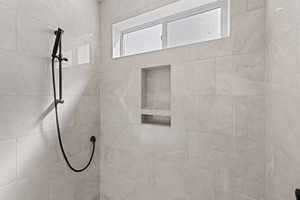 Full bath featuring tiled shower