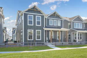 View of front of house featuring board and batten siding and covered porch