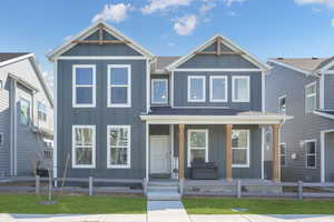 View of front facade featuring board and batten siding and covered porch
