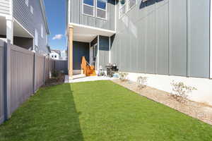 View of yard with entry steps and a patio