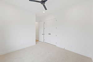 Unfurnished bedroom featuring baseboards, carpet floors, recessed lighting, a closet, and ceiling fan