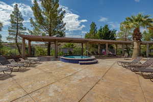 View of patio featuring a hot tub and fence