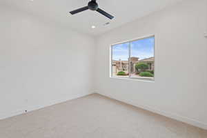 Spare room with ceiling fan, baseboards, light colored carpet, and recessed lighting