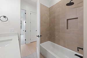 Full bath featuring washtub / shower combination