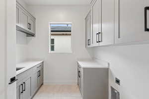 Washroom with hookup for an electric dryer and baseboards