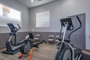 Exercise room with carpet flooring and recessed lighting