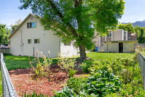 View of side of home with a mountain view