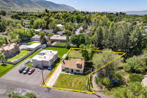 Aerial view of property's location featuring property parcel outlined and a mountain backdrop