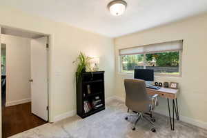 Office with baseboards and carpet flooring
