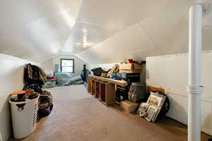 Bonus room featuring carpet floors and vaulted ceiling