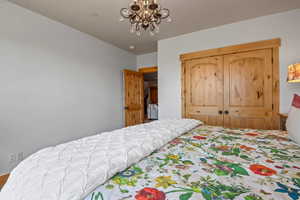 Bedroom featuring a closet and a chandelier