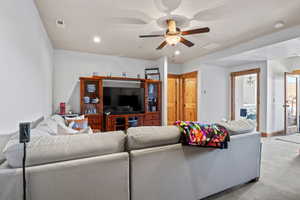 Living area with light colored carpet, a ceiling fan, visible vents, and recessed lighting